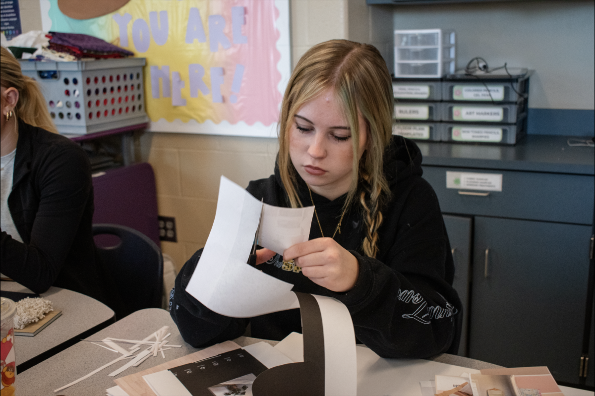 Olivia Johnson, 10, creates a physical design board in interior design on Dec. 4.