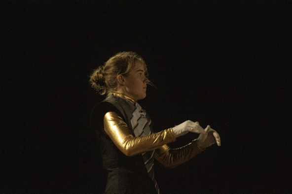 Keeping the tempo, Lily Meek, 12, stands proud in front of the band. As the drum major, they had to make sure the rest of the band was in time while holding the speed themselves.