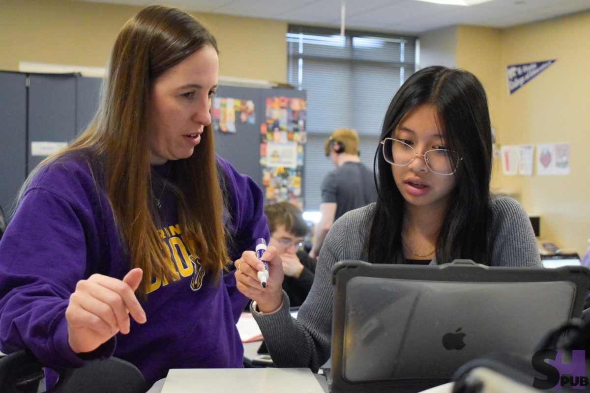 Karla DeCoster, math teacher, helps Kayley Tran, 12, with calculus on Dec. 12.