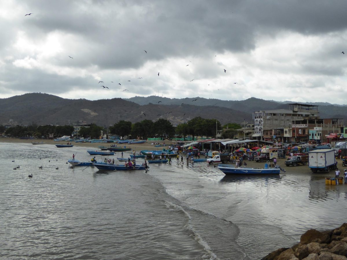 Ships and a number of markets line up along the coast of Puerto López, Ecuador. These coast have recently been overtaken by gang violence targeting fishermen.