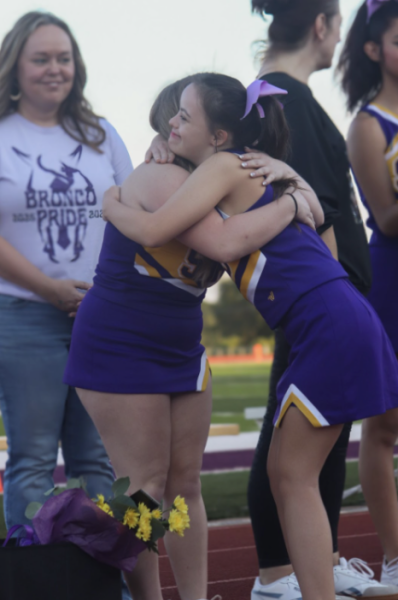 Rylee Jones, 12, embraces Willow Marcum, 10, on their senior night for cheer. Jones and Marcum met through the proximity of unified classes and sports.
