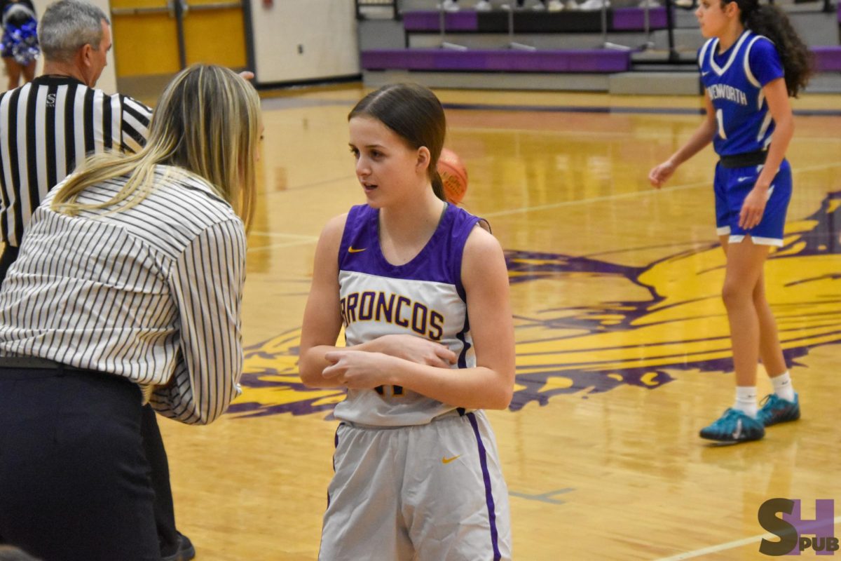 On Feb. 10, Paige Husa, varsity girls basketball coach, gives Brooklyn Love, 12, a pep talk. 