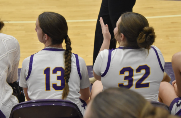 Adeline McConnell and Keely Rodden, 10, support their teammates from the bench. On Feb. 10, the Broncos defeated Leavenworth 54-37.
