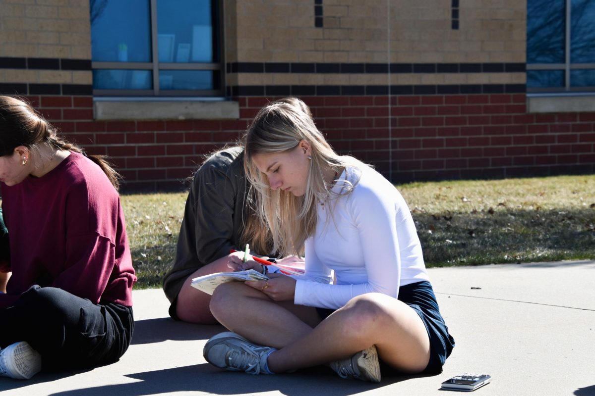 On Feb. 27, Lily Hunt, 12, works outside on their calc work for the day.