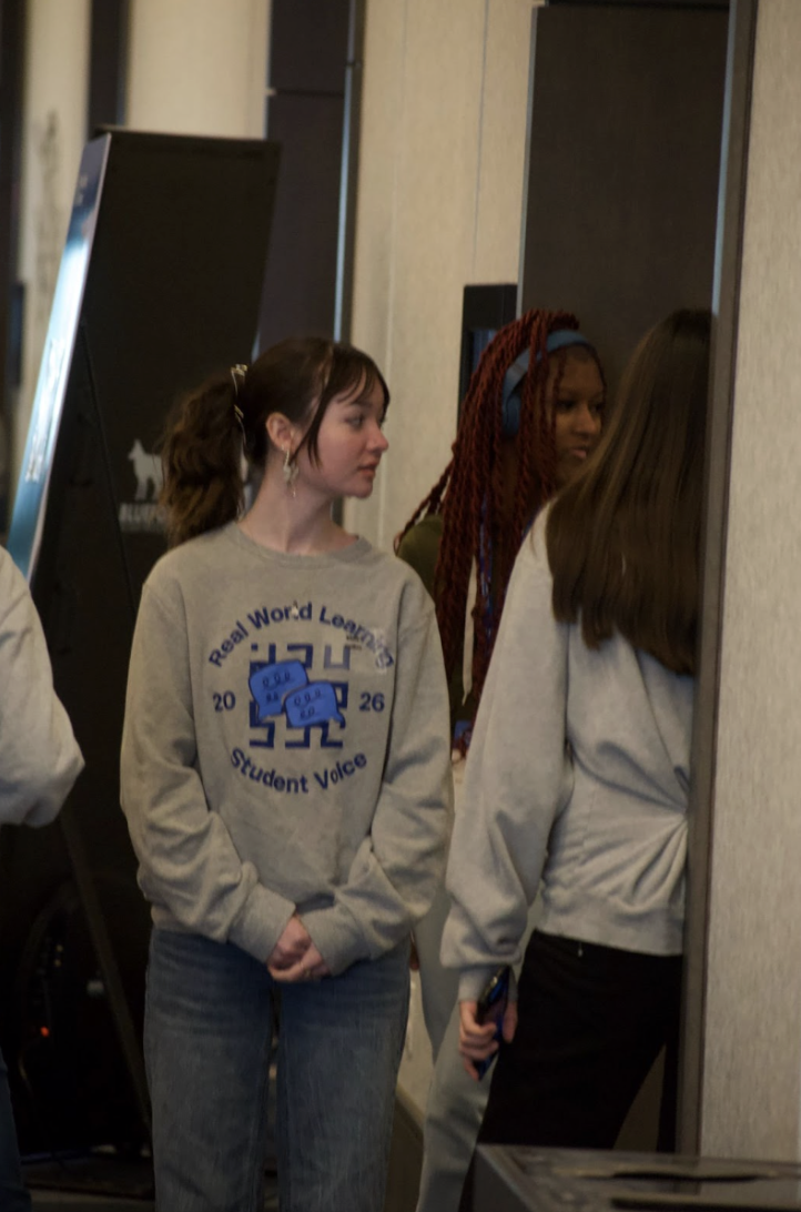 Elsie Collins, 12, talks with another Real World Learning Student Ambassador. This is Collins’ first year in the program. 