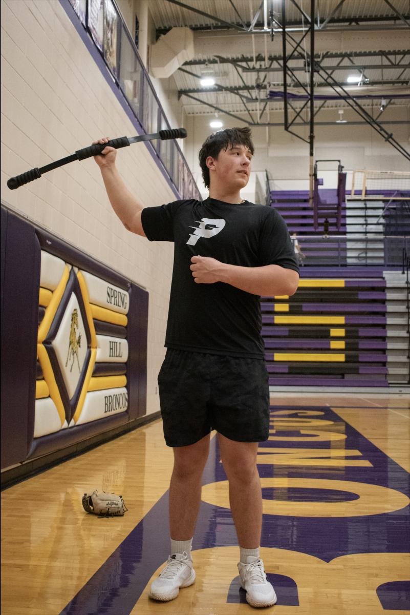 On Feb. 26, Ethan Hill, 11, warms up their arm to throw a bullpen at baseball tryouts.