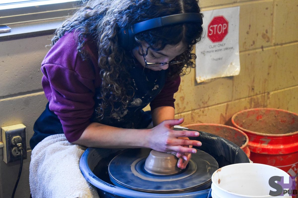 On March 27, Heidy Manzanilla-Munoz, 12, molds their clay on the pottery wheel in ceramics.