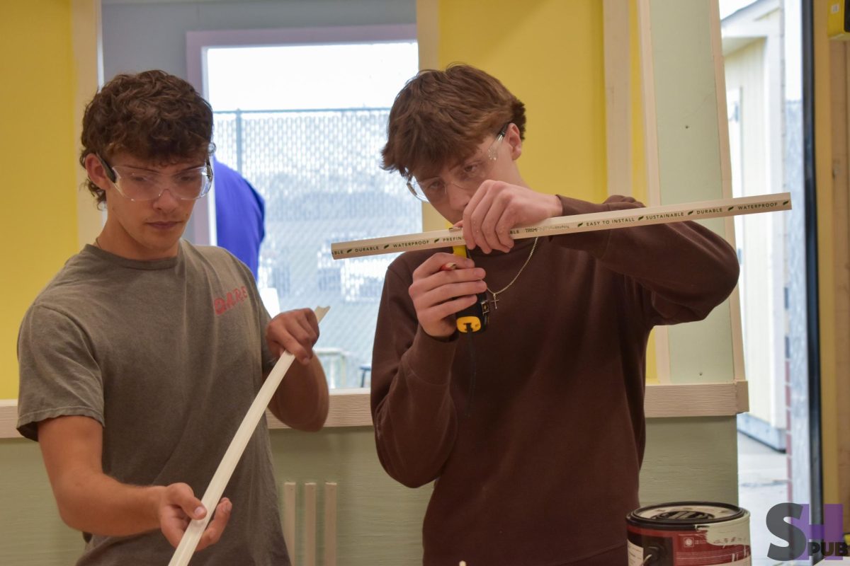 On April 1, Shaw Stewart and Mason Claar, 10, measure moulding.