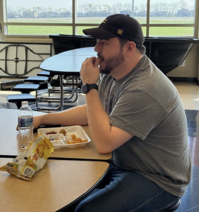 Preparing to feed hundreds of students lunch, Connor Johnston, lunch and shop supervisor, fuels up. Seeing many different students’ faces a day, Johnston works hard to remember them all.