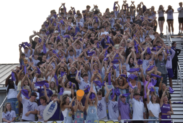 Students raise their hands in hopes of a successful kick. Football season was a time that brought many together, creating a culture for everyone.